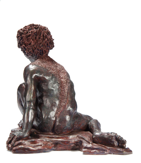 Back View: ENKIDU, the “wild man” companion of the Mesopotamian hero Gilgamesh; a crouching male figure, arms and legs extended, with hair like a lion’s pelt.