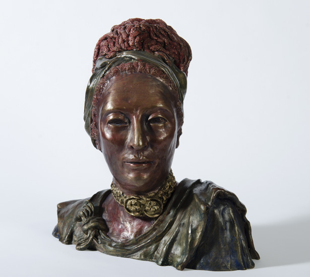 SHEBA, myhto-historical bust of a draped woman with headband and dreadlocks, head turned to the left. 